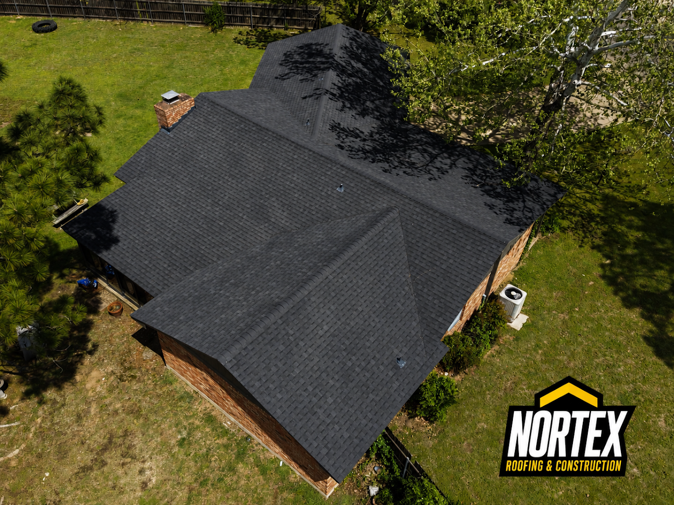 Overhead view of a finished charcoal shingle roof on a brick home in Wichita, KS