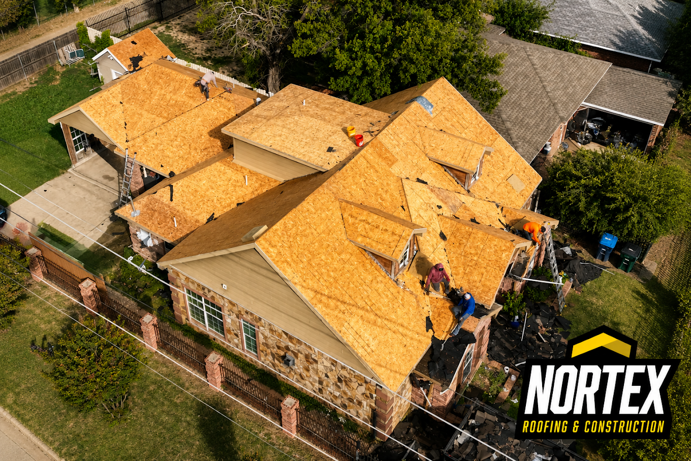 Drone photo of a Nortex crew installing new decking during a storm damage roof rebuild in Tulsa, OK